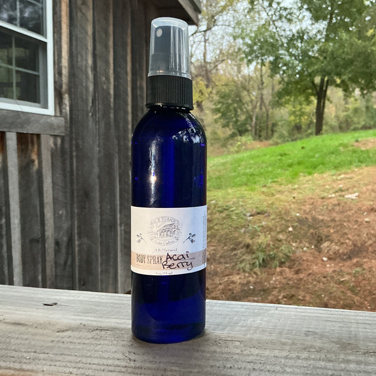 Blue spray bottle with a label on a wooden surface outdoors