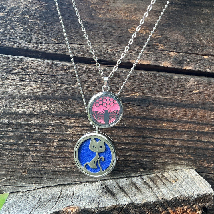 Necklace with two pendant charms on a wooden surface