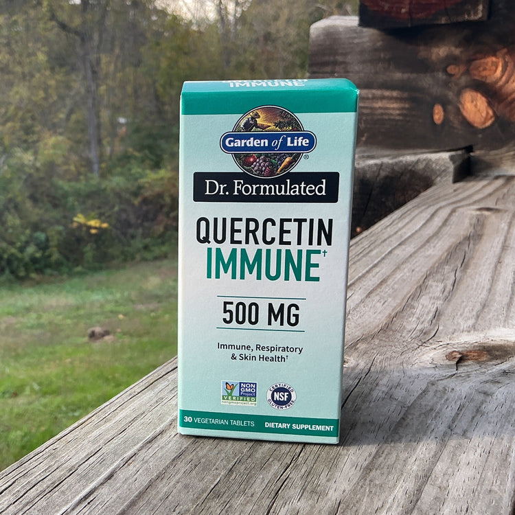 Box of Dr. Formulated Quercetin Immune supplement on a wooden surface with a natural background