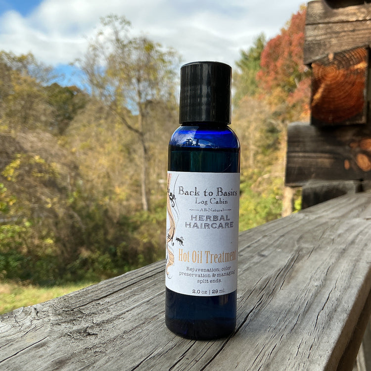 Bottle of herbal haircare product on a wooden surface with a natural background