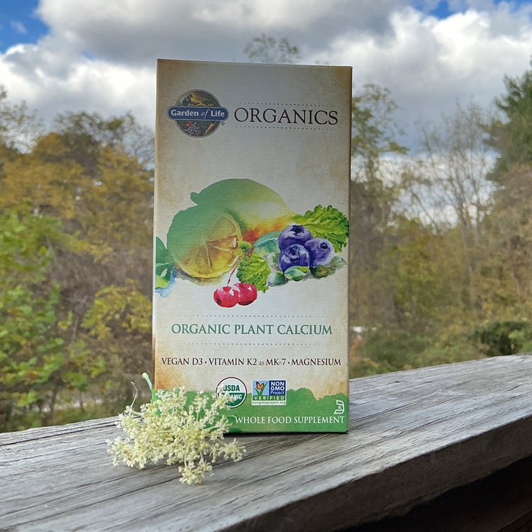 Garden of Life Organics plant calcium supplement box on a wooden surface with a natural background