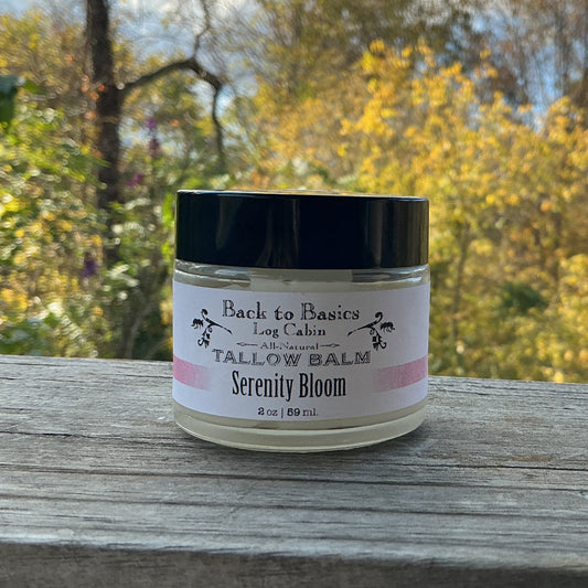 Jar of tallow balm labeled 'Serenity Bloom' on a wooden surface with a natural background