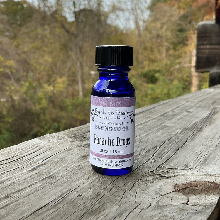 Bottle of Blended Oil Arachne Drops on a wooden surface with a natural background