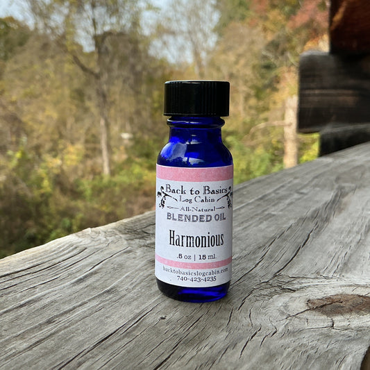 Bottle of 'Harmonious' blended oil on a wooden surface with a natural background