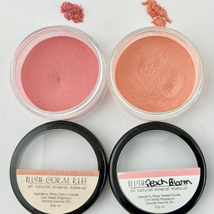 Four containers of blush makeup with visible blush colors on a white background