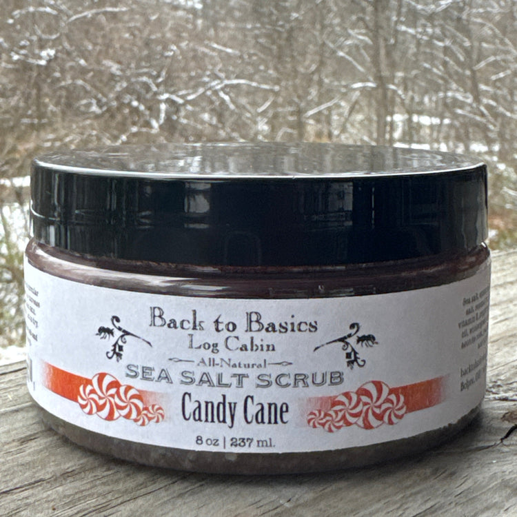 Jar of candy cane sea salt scrub with a blurred snowy background