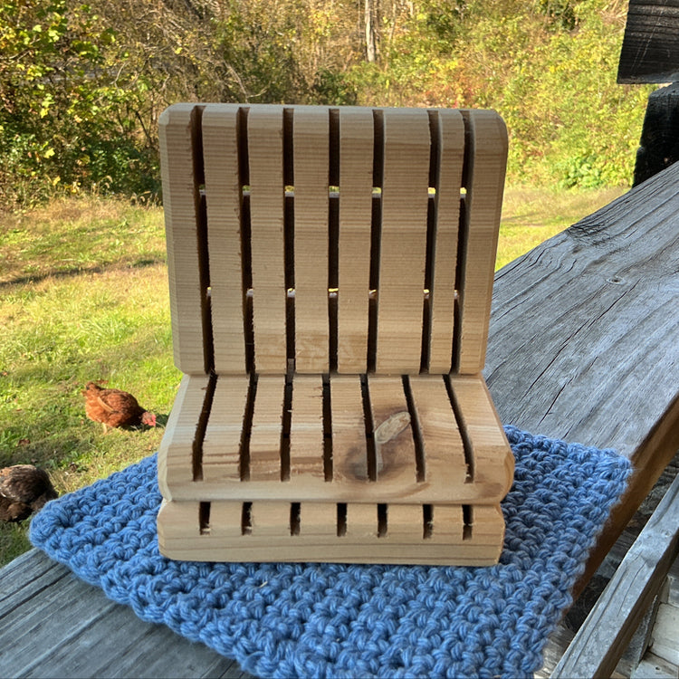Wooden chair on a blue mat with chickens in the background