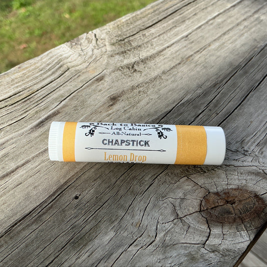Chapstick stick on a wooden surface with a natural background