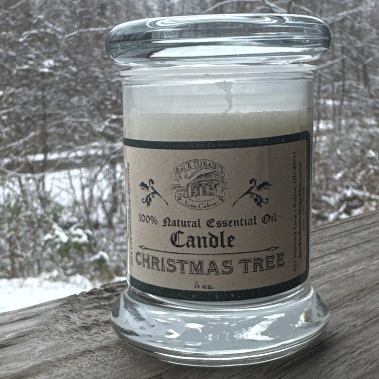 Jar of Christmas Tree candle with a snowy outdoor background