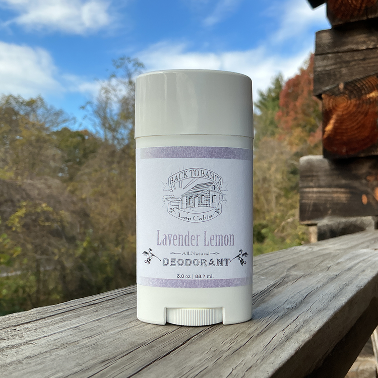 Deodorant stick with lavender lemon scent on a wooden surface outdoors