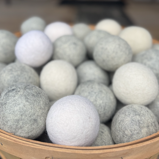 Basket filled with gray and white wool dryer balls