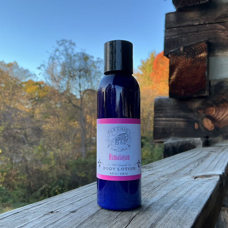 Bottle of Himalayan body lotion on a wooden surface with a natural background
