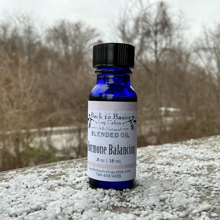 Bottle of Blended Oil on a snowy surface with a blurred natural background