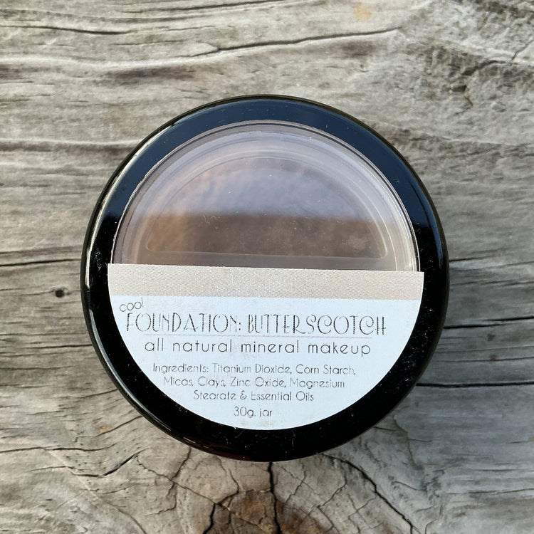 Jar of 'Butterscotch' foundation on a wooden surface