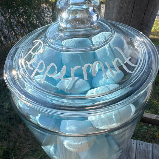 Clear glass jar with a lid on a wooden surface