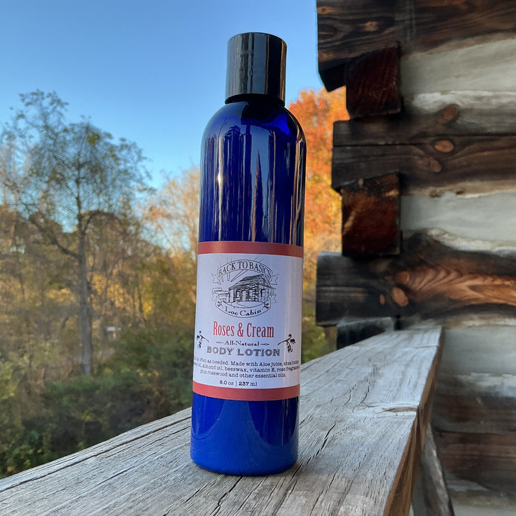Blue bottle of body lotion with a label on a wooden surface outdoors