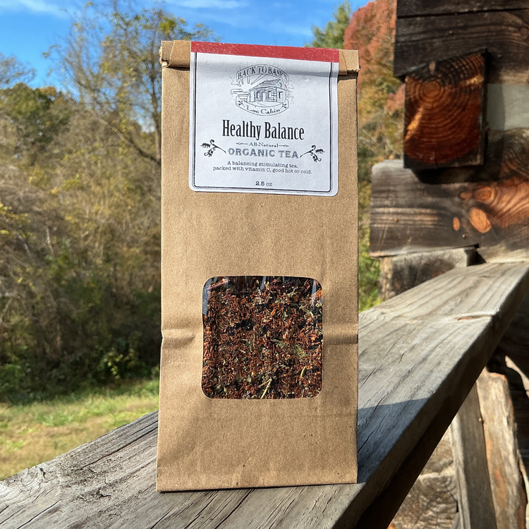 Tea package labeled 'Healthy Balance' on a wooden surface with a natural background