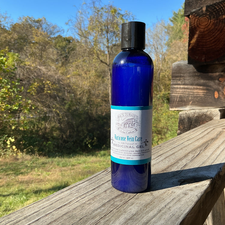 Blue bottle with a label on a wooden surface outdoors