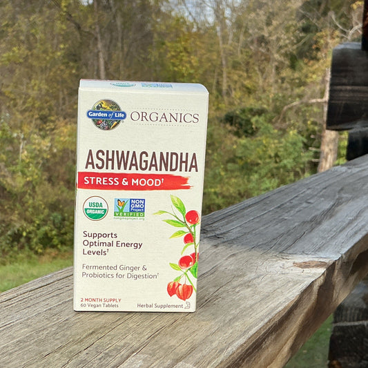 Box of Garden of Life Organics Ashwagandha supplement on a wooden surface with a natural background