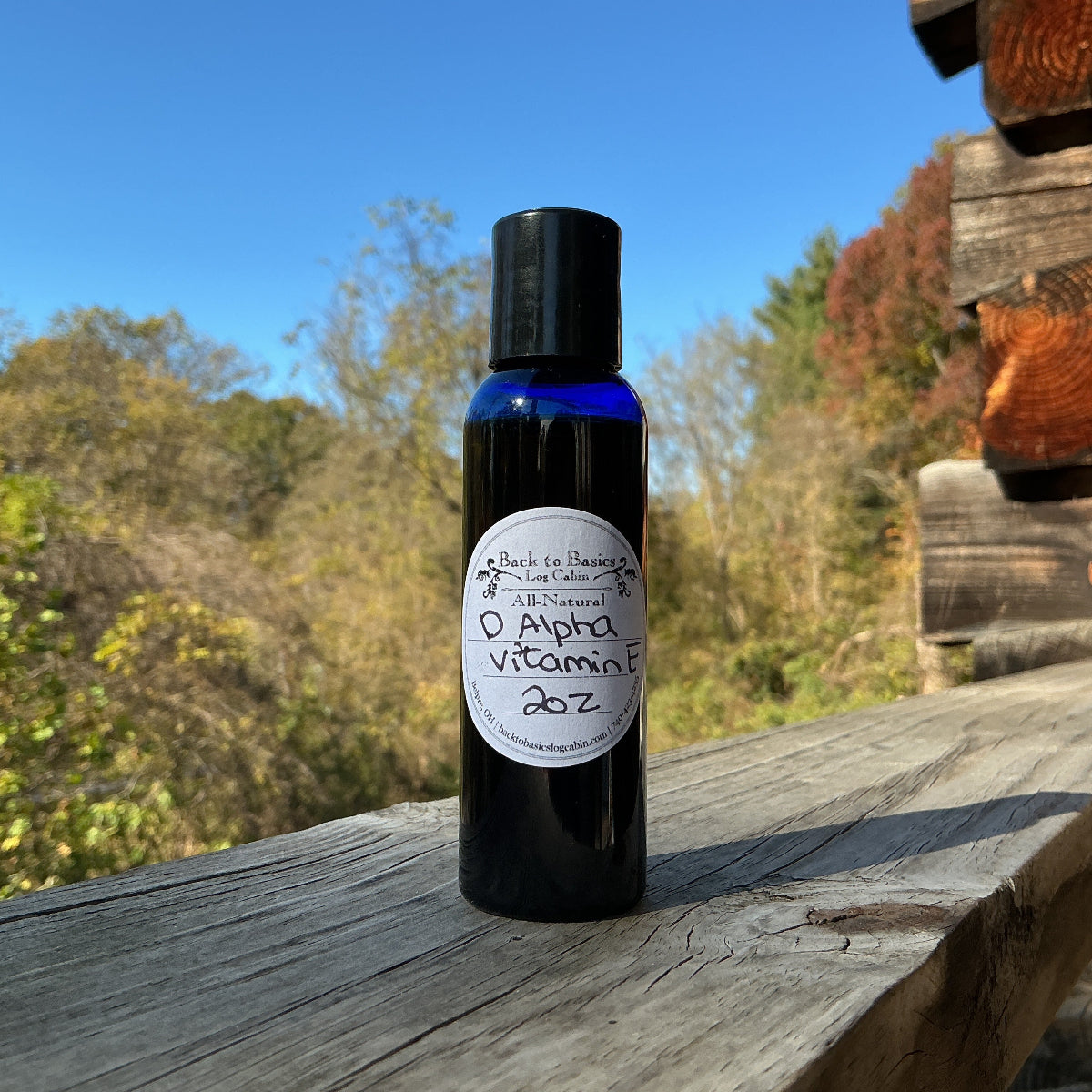 Bottle of Alpha Vitamin 20Z on a wooden surface with a natural background