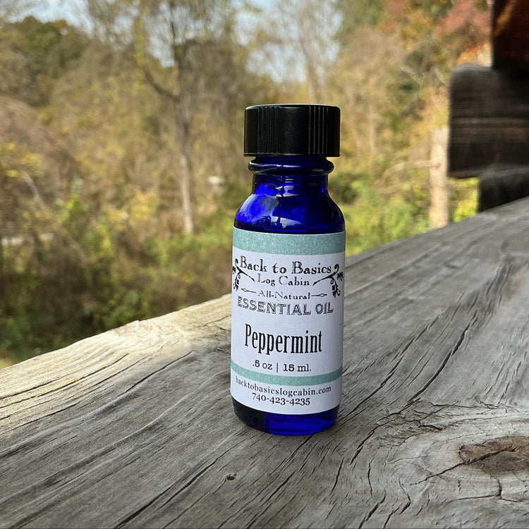 Peppermint essential oil bottle on a wooden surface with a natural background