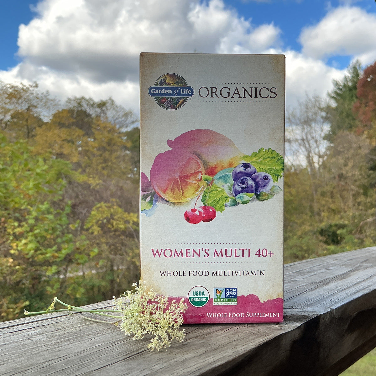 Garden of Life Organics Women's Multi 40+ multivitamin box on a wooden surface with a natural background