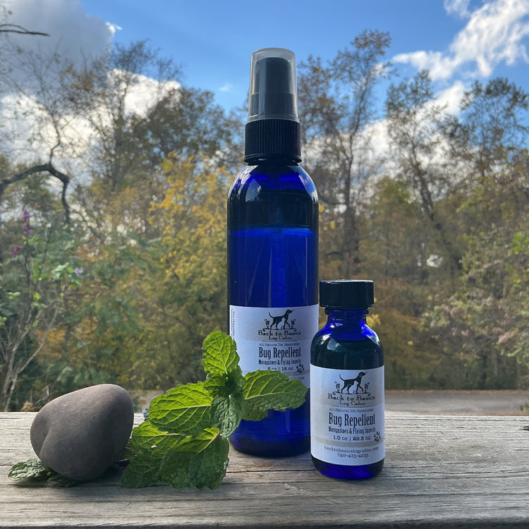 Two blue bottles with labels on a wooden surface outdoors