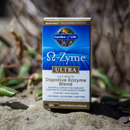 Box of Garden of Life Omega-Zyme Ultra Digestive Enzyme Blend on a natural background