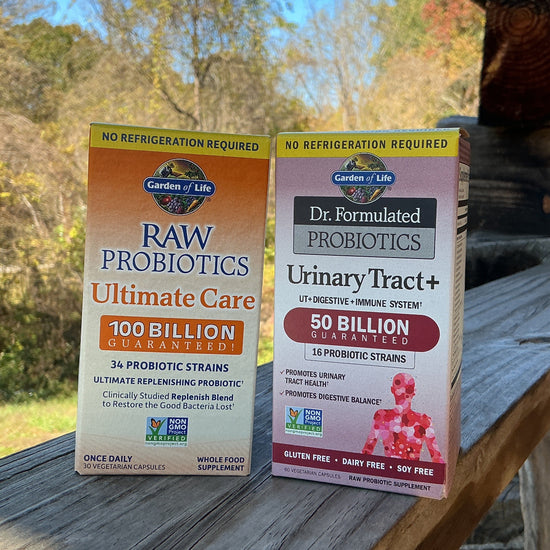 Two boxes of Garden of Life probiotics on a wooden surface with a natural background.