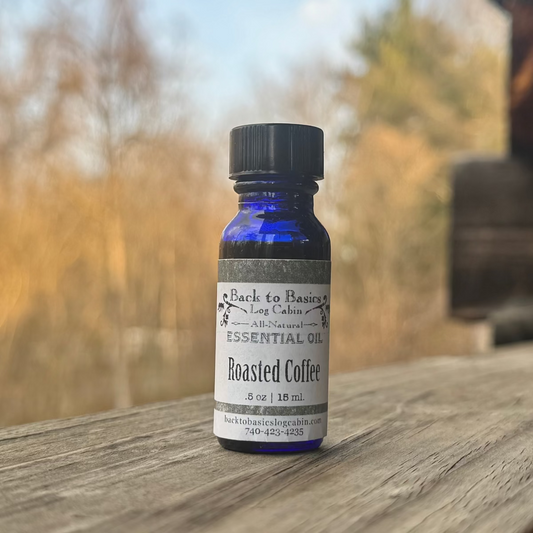 Bottle of roasted coffee essential oil on a wooden surface with a blurred natural background