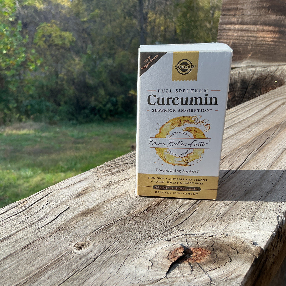 Box of Curcumin supplement on a wooden surface with a natural background