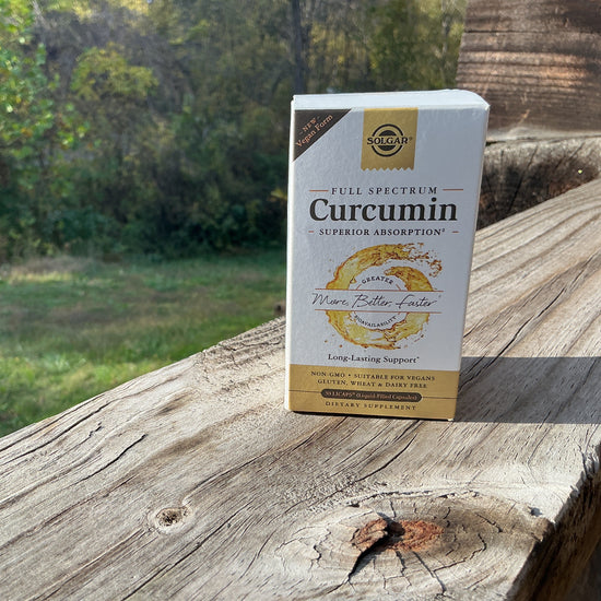 Box of Curcumin supplement on a wooden surface with a natural background