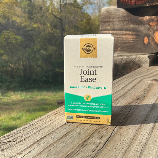 Box of Solgar Joint Ease supplement on a wooden surface with a natural background
