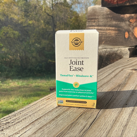 Box of Solgar Joint Ease supplement on a wooden surface with a natural background