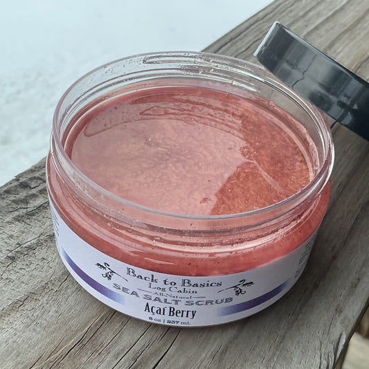 Jar of red salt scrub with a label on a wooden surface