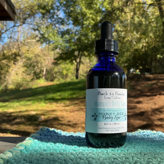 Blue glass bottle with dropper on a green textured surface outdoors
