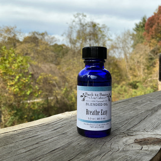 Bottle of 'Breathe Easy' blended oil on a wooden surface with a natural background