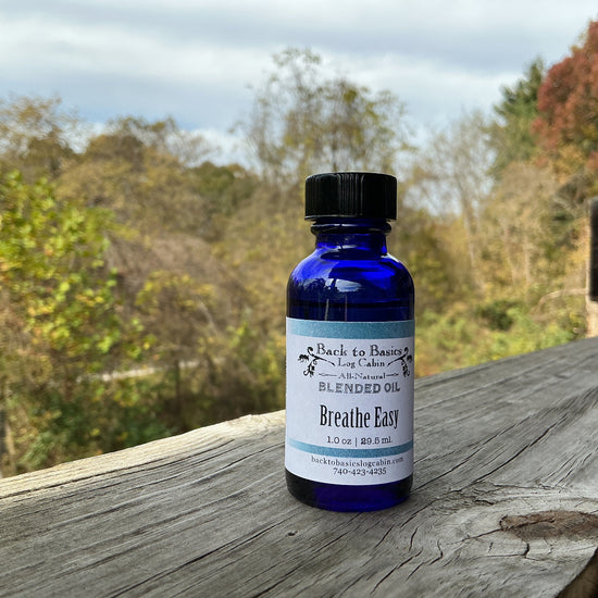 Bottle of 'Breathe Easy' blended oil on a wooden surface with a natural background
