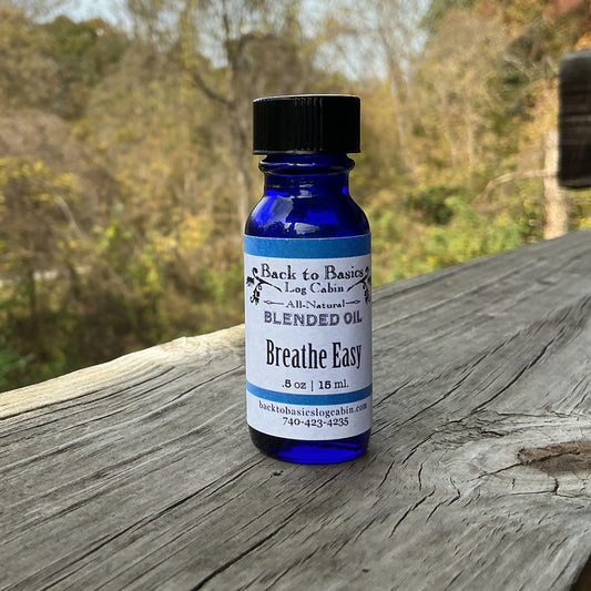 Blue bottle labeled 'Breathe Easy' on a wooden surface with a natural background