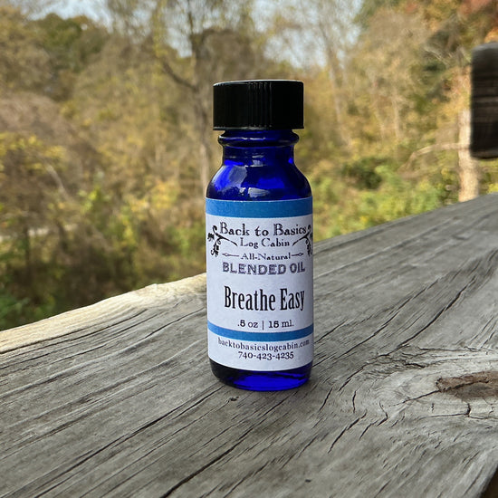 Blue bottle labeled 'Breathe Easy' on a wooden surface with a natural background