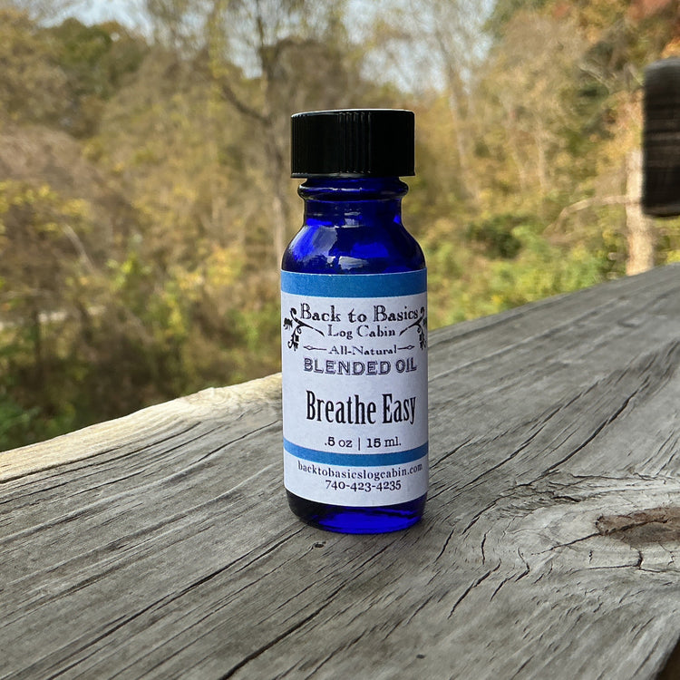 Blue bottle labeled 'Breathe Easy' on a wooden surface with a natural background