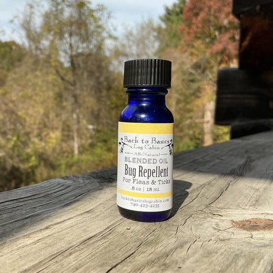 Bottle of bug repellent on a wooden surface with trees in the background