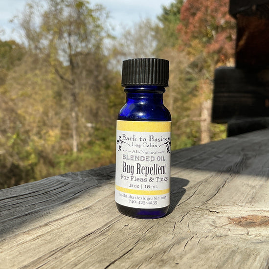 Bottle of bug repellent on a wooden surface with trees in the background