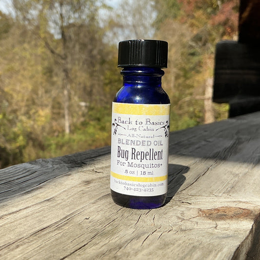 Bottle of Black & Bluestone bug repellent on a wooden surface with a natural background