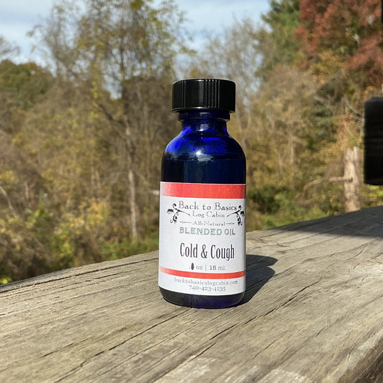 Bottle of cold and cough syrup on a wooden surface with trees in the background