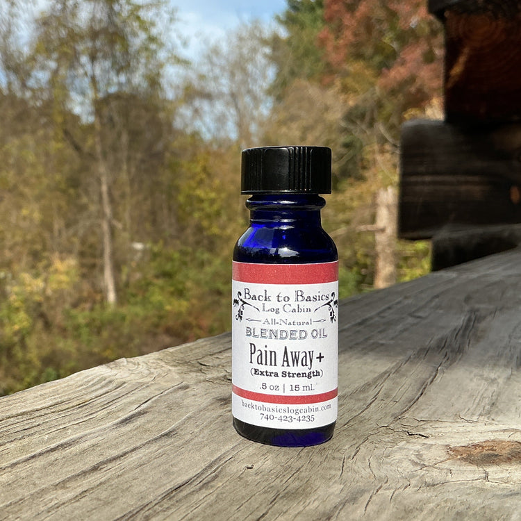 Bottle of 'Pain Away' on a wooden surface with a natural background