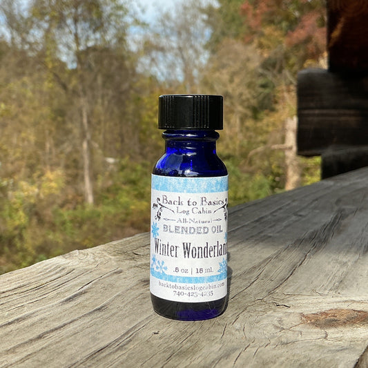 Blue bottle with black cap on a wooden surface with a forest background