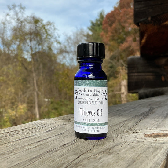 Bottle of Thieves Oil on a wooden surface with a natural background