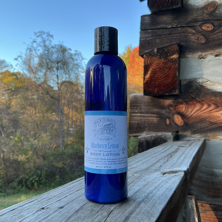 Blue bottle of body lotion on a wooden surface with a natural background