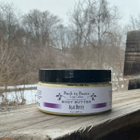 Jar of body butter labeled 'Back to Basics' on a wooden surface with a natural background